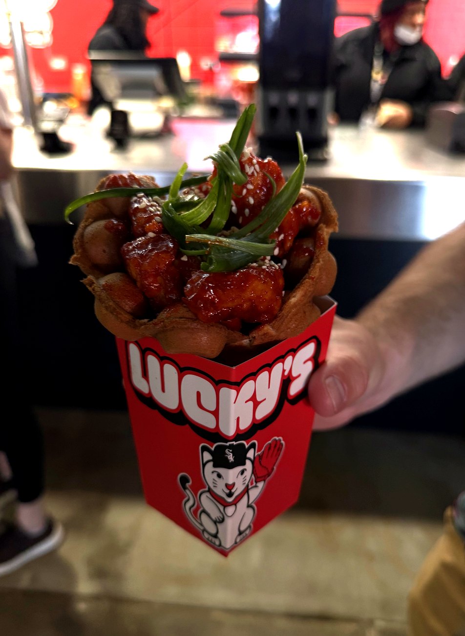 The Gochujang Bubble Waffle at Lucky's: a bubble-waffle cone filled with gochujang-glazed crispy chicken, green onion, and toasted sesame