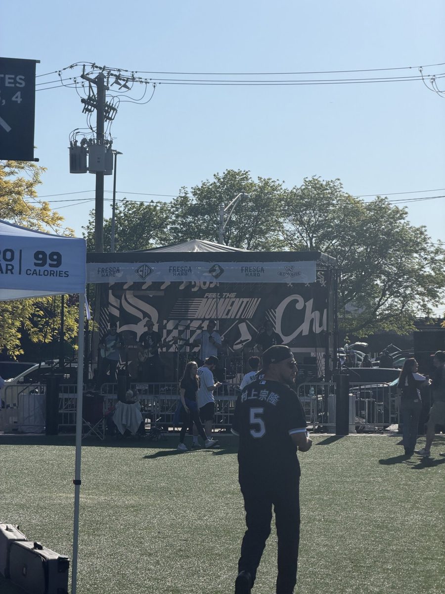 The Champions Brick Plaza signage at Gate 4 outside Rate Field, with Sox fans gathered nearby pre-game