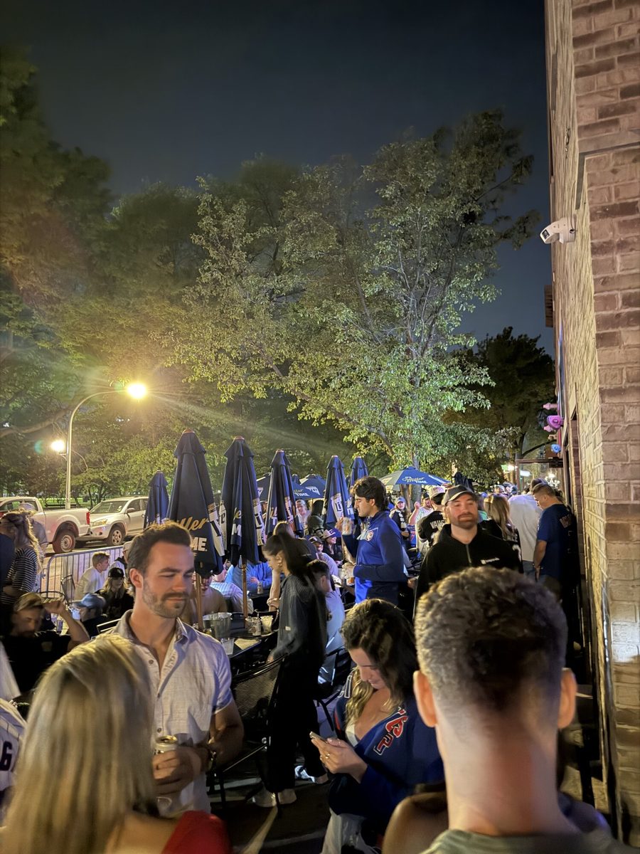 A Bridgeport bar outdoor patio at night with Sox fans gathered post-game under string lights