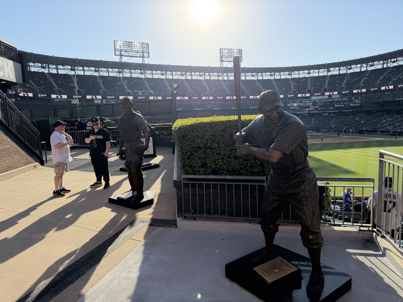 Bronze statues of White Sox greats along the outfield concourse at Rate Field